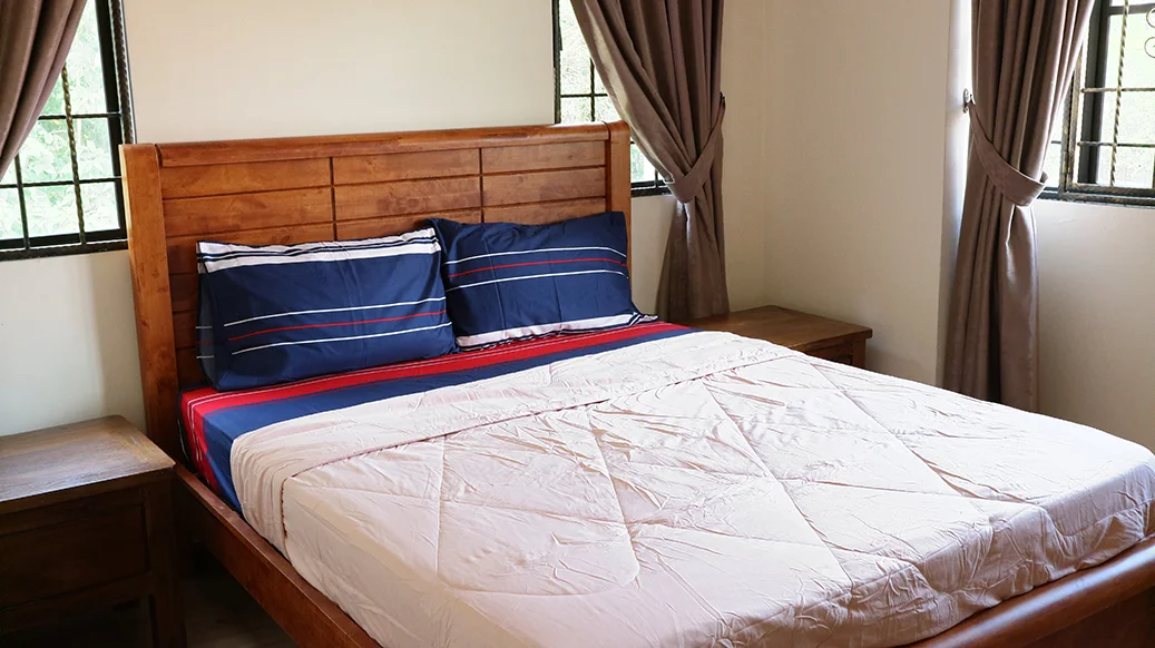 A single room with a queen-size bed and a private bathroom